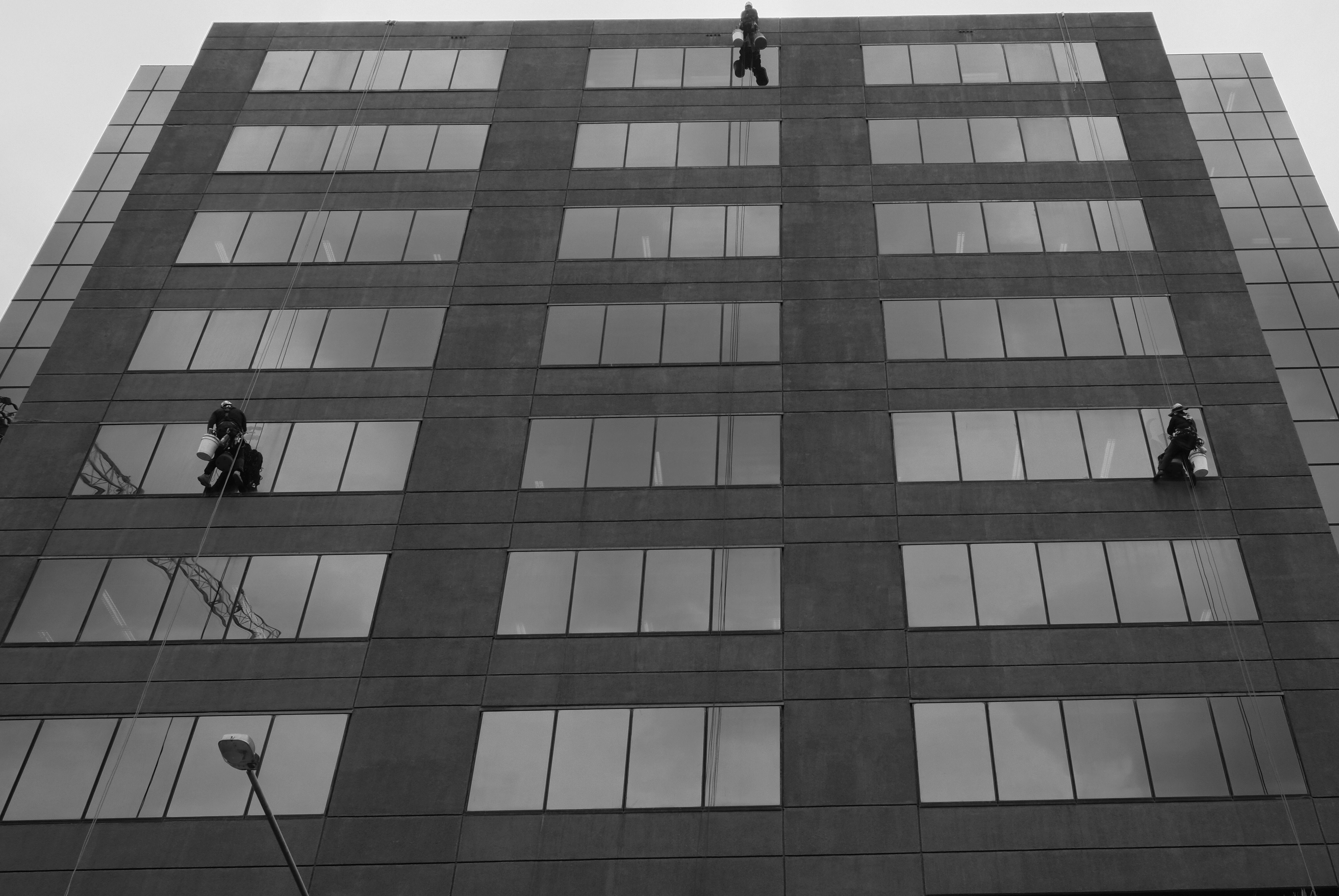 Commercial rope access technicians working on a high-rise building in Bristol